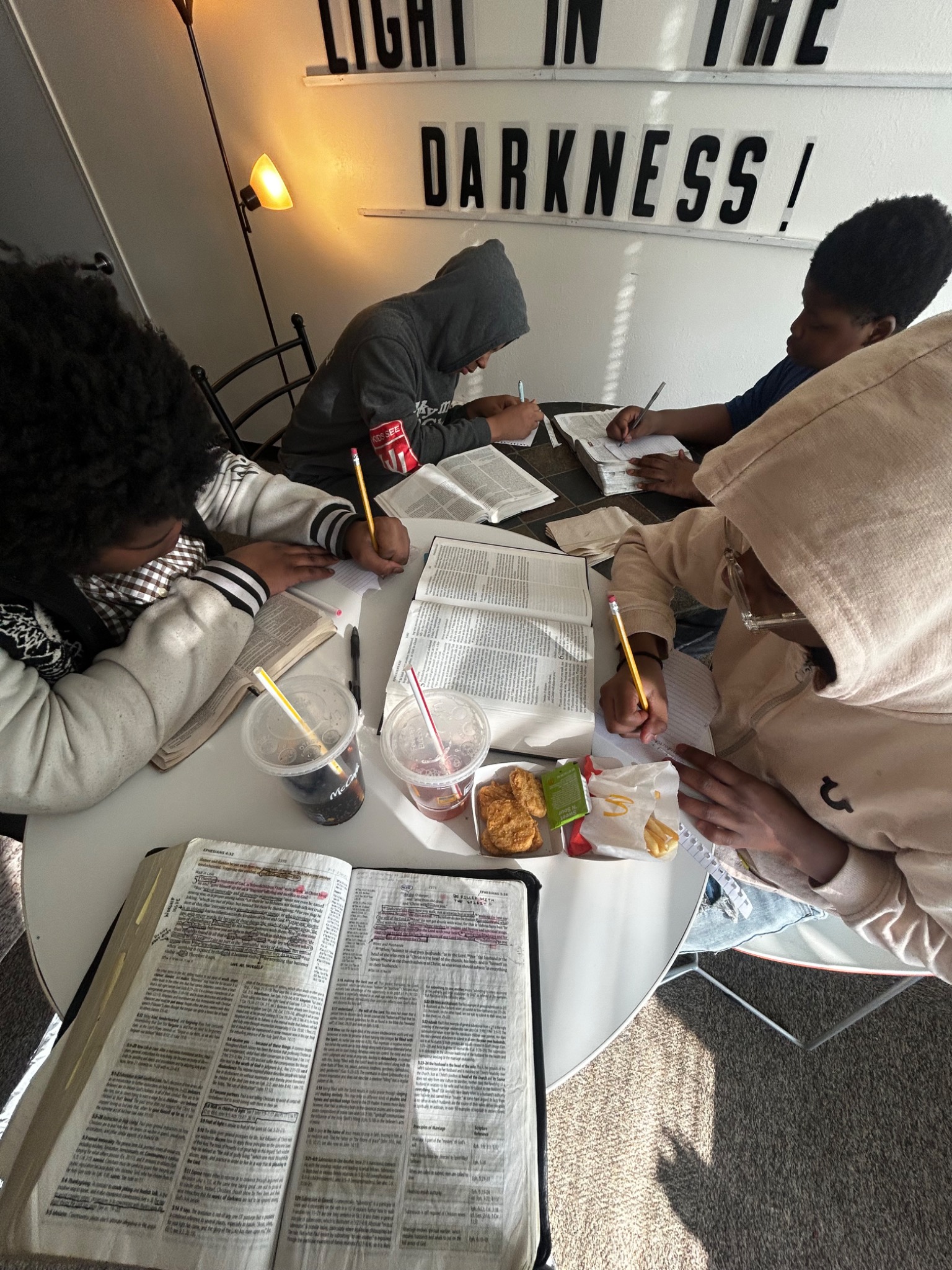 Teenagers studying their Bibles together around a table